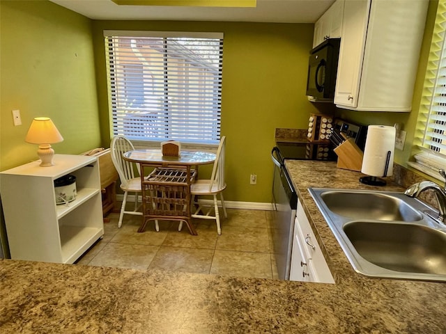 kitchen featuring dishwasher, white cabinets, sink, range with electric stovetop, and light tile patterned floors