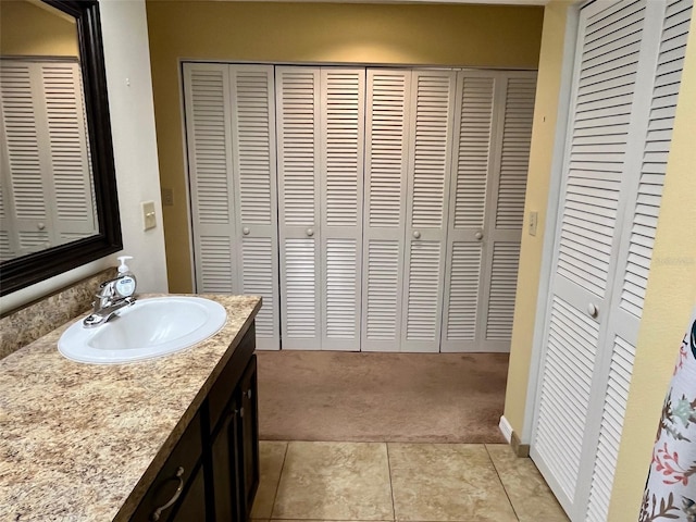 bathroom with tile patterned floors and vanity