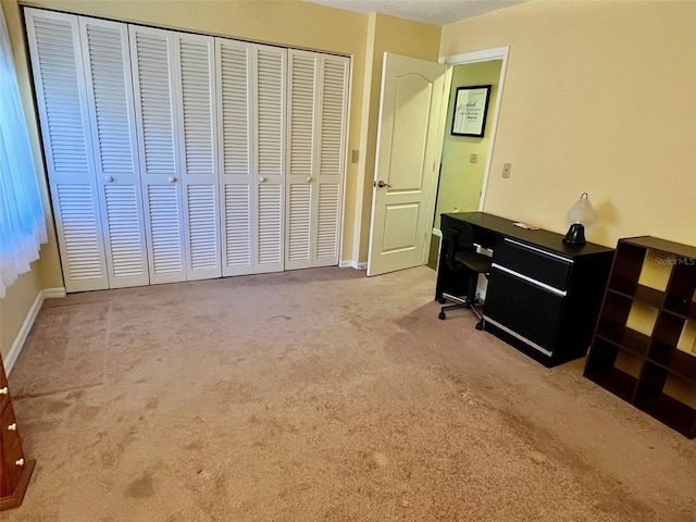 bedroom featuring light colored carpet and a closet