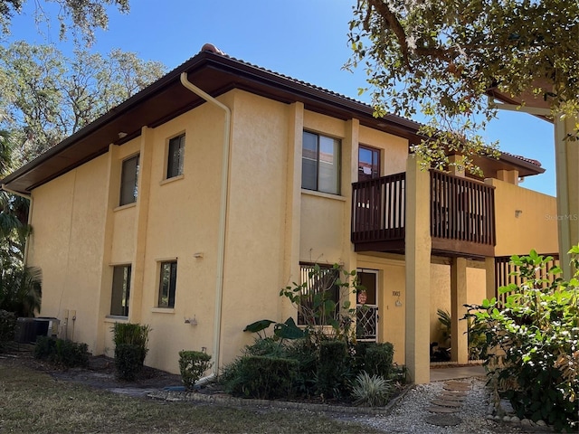 exterior space with central AC and a balcony