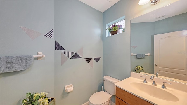 bathroom featuring toilet and vanity