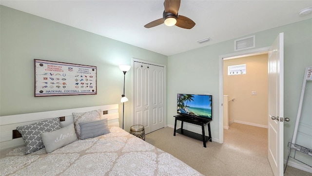 carpeted bedroom with ceiling fan and a closet