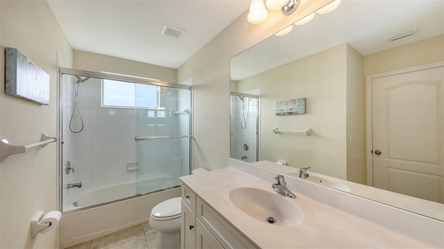 full bathroom featuring toilet, tile patterned flooring, vanity, and enclosed tub / shower combo