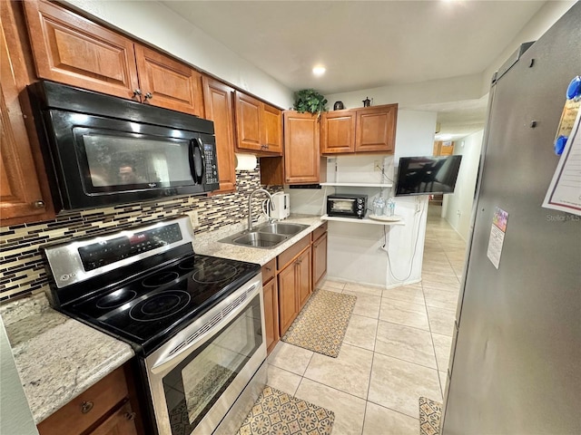 kitchen with backsplash, electric range, sink, and light tile patterned floors