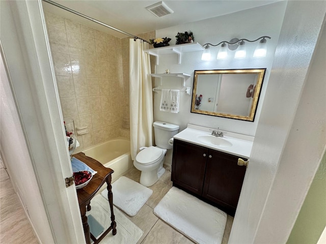 full bathroom featuring toilet, vanity, tile patterned floors, and shower / bath combo with shower curtain