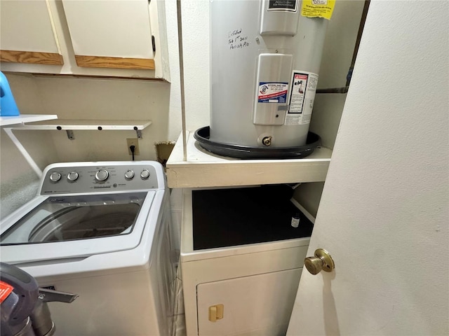 laundry room with water heater, cabinets, and independent washer and dryer