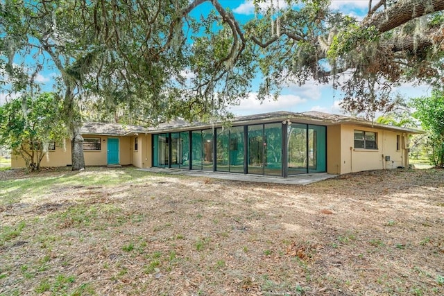 back of house featuring a sunroom