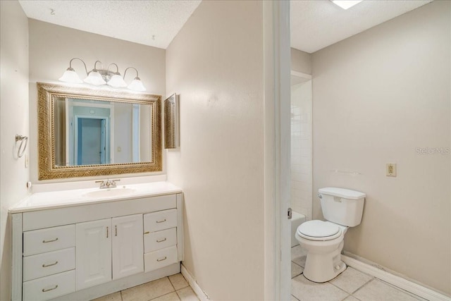 bathroom with tile patterned floors, vanity, toilet, and a textured ceiling