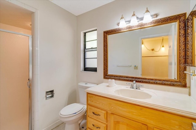 bathroom with vanity, toilet, and walk in shower