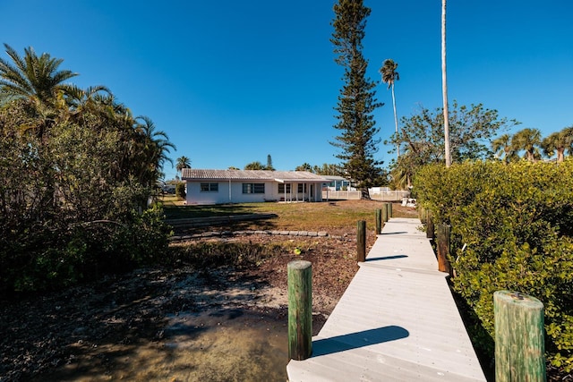view of dock with a yard