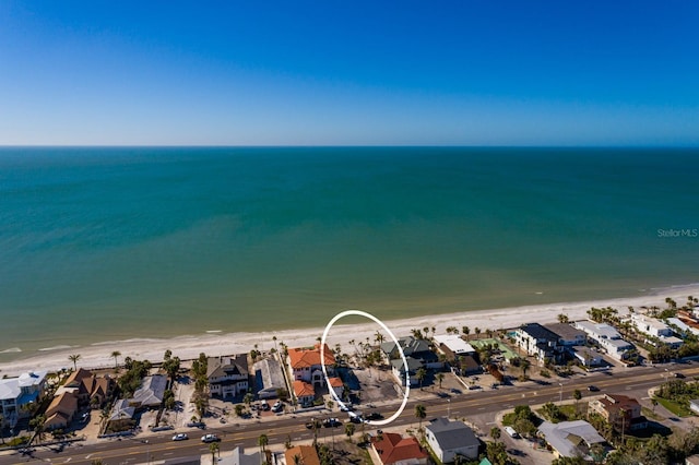 drone / aerial view featuring a beach view and a water view