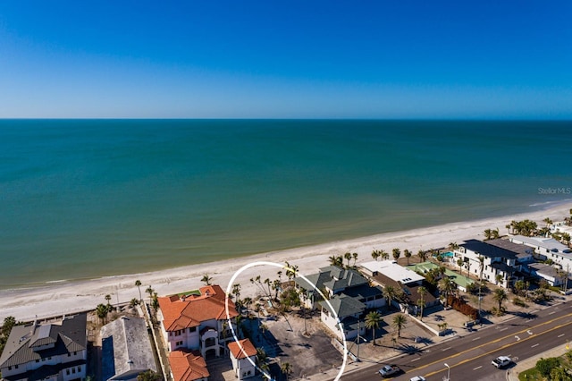 bird's eye view with a water view and a beach view