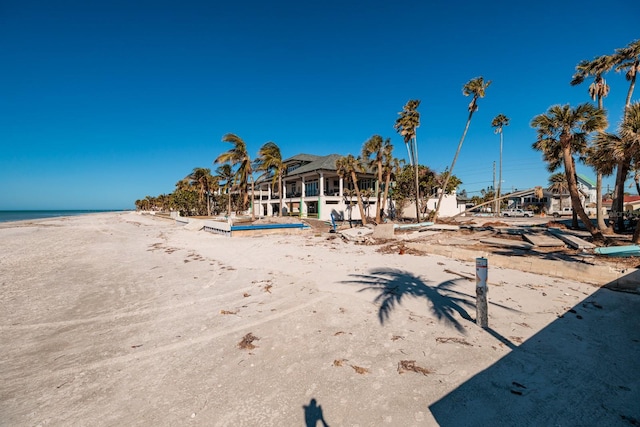 exterior space with a water view and a beach view