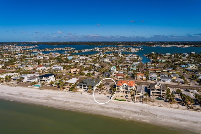 bird's eye view with a water view and a beach view