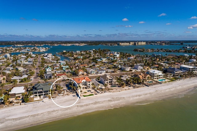 birds eye view of property with a view of the beach and a water view
