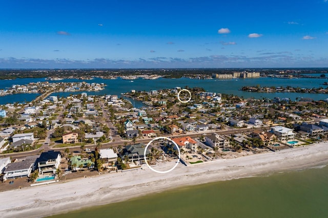 drone / aerial view featuring a water view and a view of the beach
