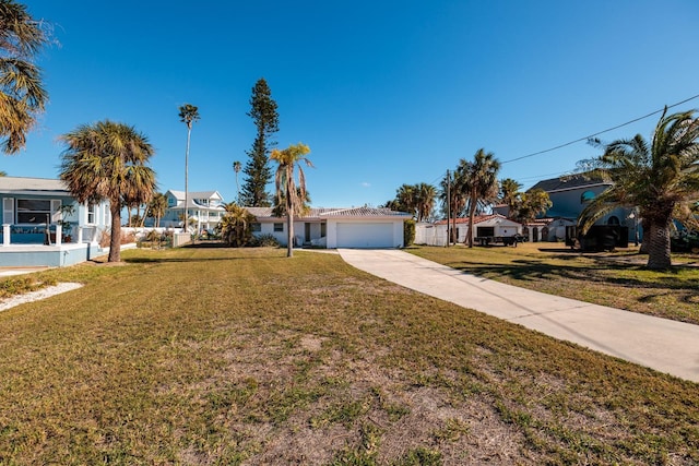 15815 Redington Dr, Redington Beach, FL 33708 - ranch-style home with concrete driveway, a front yard, a garage, and a residential view