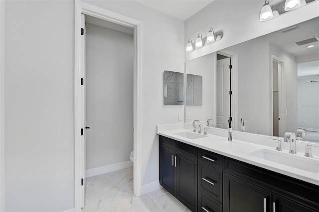 bathroom with vanity and toilet