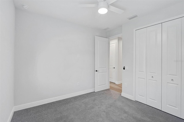 unfurnished bedroom featuring ceiling fan, light carpet, and a closet