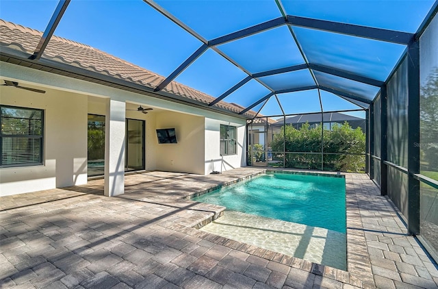 view of pool featuring a lanai, ceiling fan, and a patio area