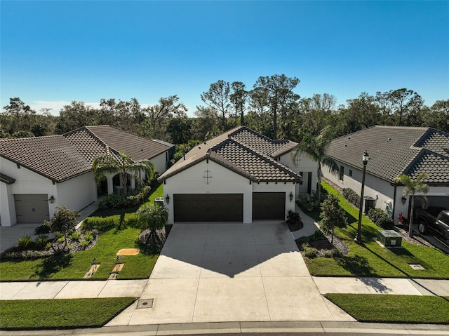 mediterranean / spanish-style home featuring a front lawn and a garage