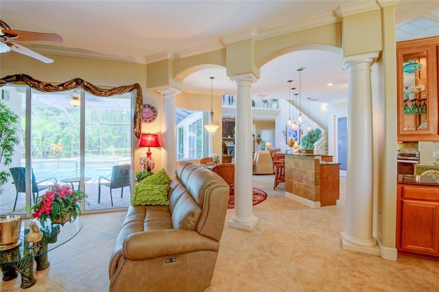 living room featuring ceiling fan, ornamental molding, light tile patterned floors, and ornate columns