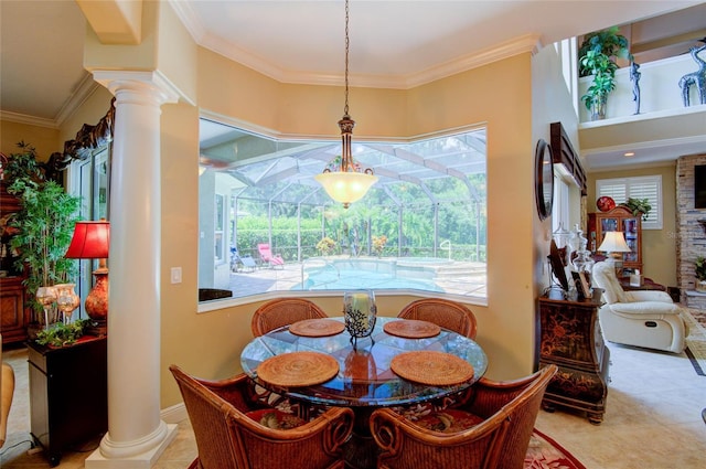 tiled dining room featuring decorative columns and ornamental molding