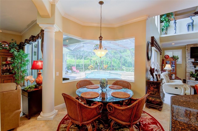 dining area featuring ornamental molding, light tile patterned floors, and ornate columns