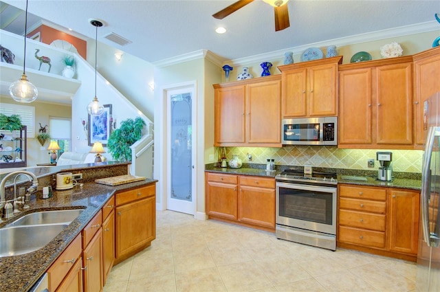 kitchen with sink, stainless steel appliances, backsplash, crown molding, and pendant lighting