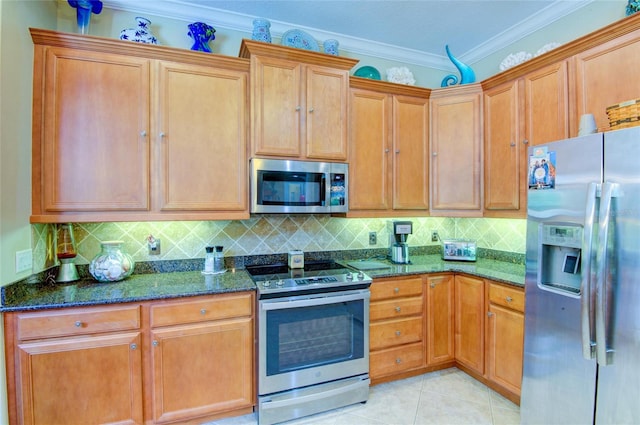 kitchen with stainless steel appliances, dark stone counters, decorative backsplash, light tile patterned flooring, and ornamental molding