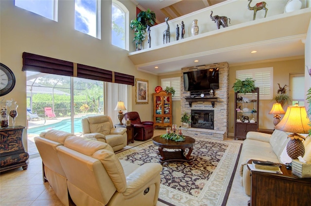 tiled living room featuring a stone fireplace, a towering ceiling, and ornamental molding