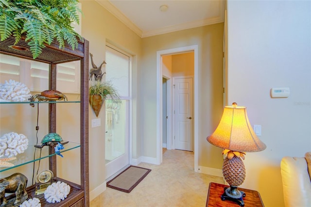 tiled foyer featuring ornamental molding