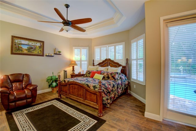 bedroom with hardwood / wood-style floors, access to outside, a raised ceiling, ceiling fan, and ornamental molding