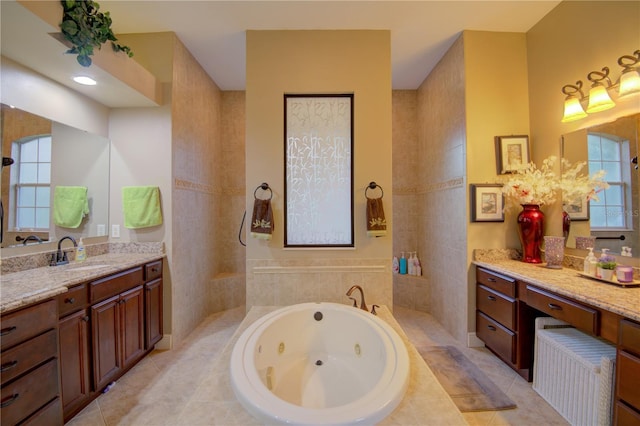 bathroom with vanity, a relaxing tiled tub, tile patterned floors, and tile walls