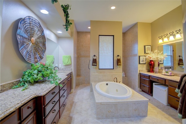 bathroom with tile patterned flooring, vanity, and plus walk in shower