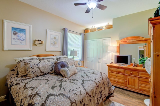 bedroom with ceiling fan, a closet, and light hardwood / wood-style flooring