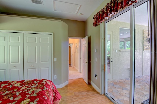 bedroom featuring a closet and light wood-type flooring