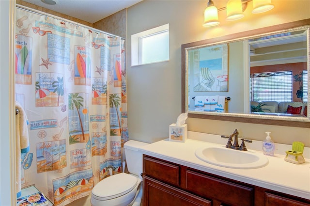 bathroom with a shower with curtain, vanity, toilet, and a wealth of natural light