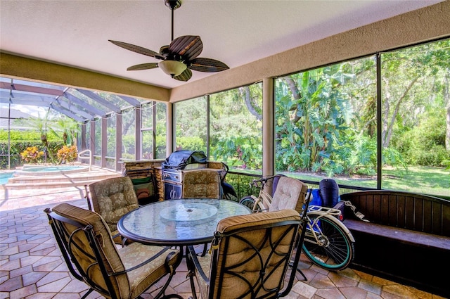 sunroom with ceiling fan and a healthy amount of sunlight