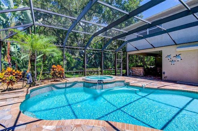 view of swimming pool with glass enclosure, an in ground hot tub, and a patio