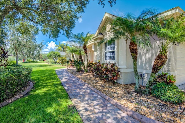 view of side of home with a lawn