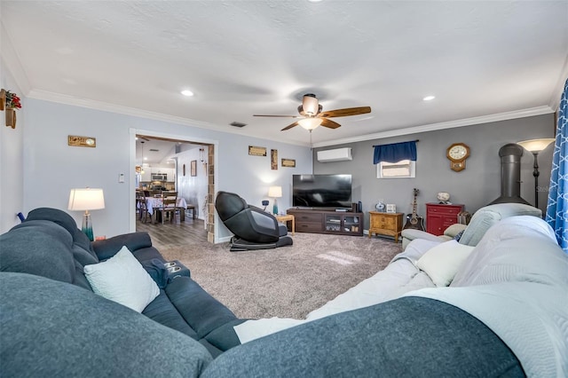 living room with ceiling fan, ornamental molding, and carpet floors