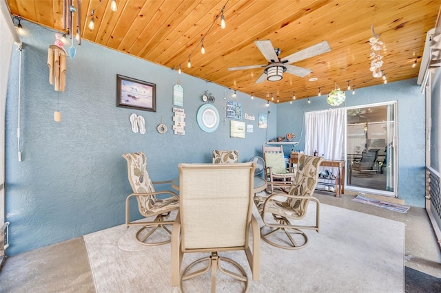 dining room with concrete flooring, ceiling fan, and wood ceiling