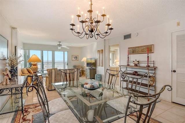 dining room with light tile patterned floors, ceiling fan with notable chandelier, and a textured ceiling