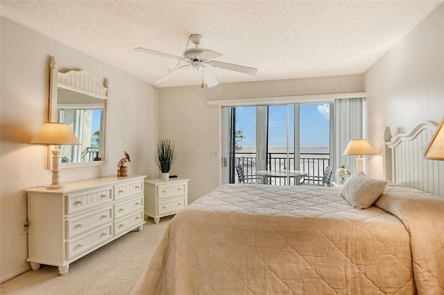 bedroom featuring access to exterior, ceiling fan, light carpet, and a textured ceiling