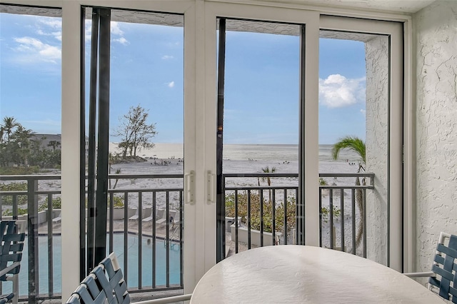 interior space featuring a view of the beach and a water view