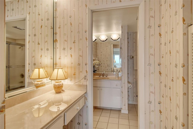 bathroom featuring tile patterned floors, vanity, and a shower with shower door