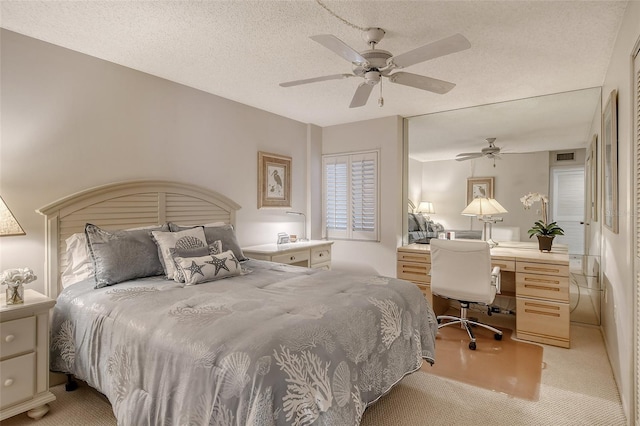 carpeted bedroom with a textured ceiling and ceiling fan