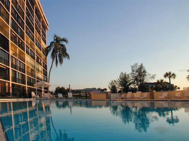 view of pool at dusk