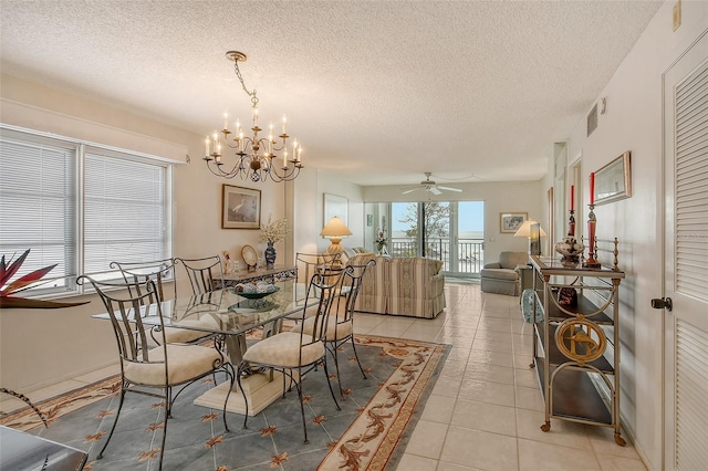 19 Whispering Sands Dr Unit 301, Sarasota, FL 34242 - dining area featuring a chandelier, a textured ceiling, light tile patterned floors, and a ceiling fan